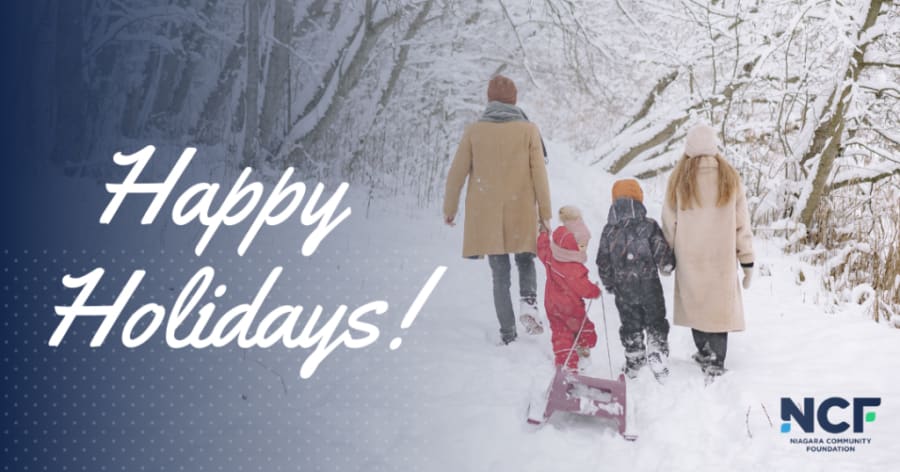 A family walks in the snow.