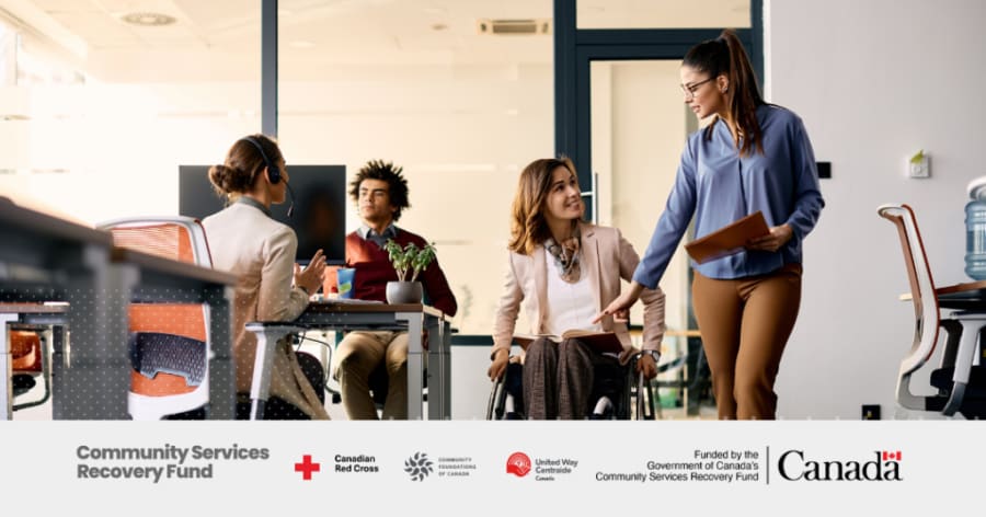 A group of young adults are gathered in an office.