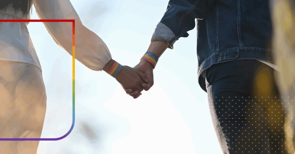 Closeup of couple holding hands.