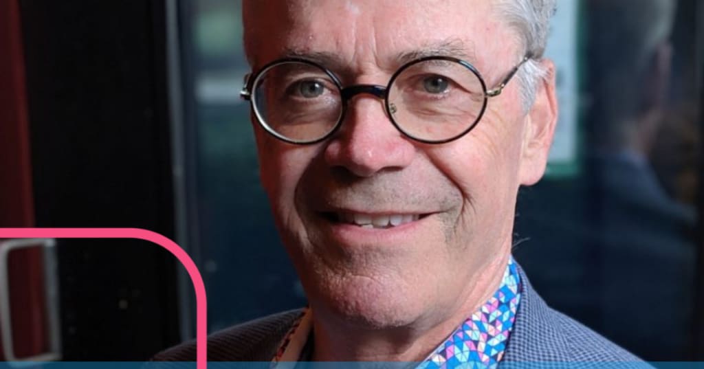 Gerald Kowalchuk wearing black rimmed glasses and smiling.