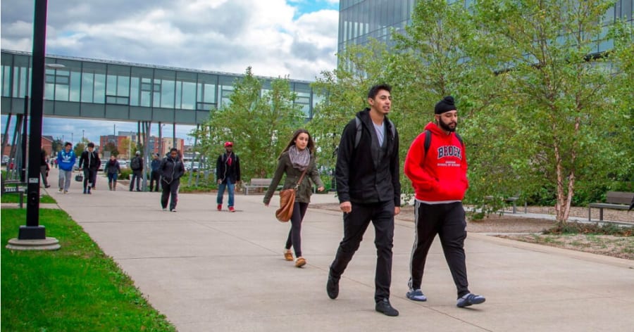 Students walking outside of university campus.