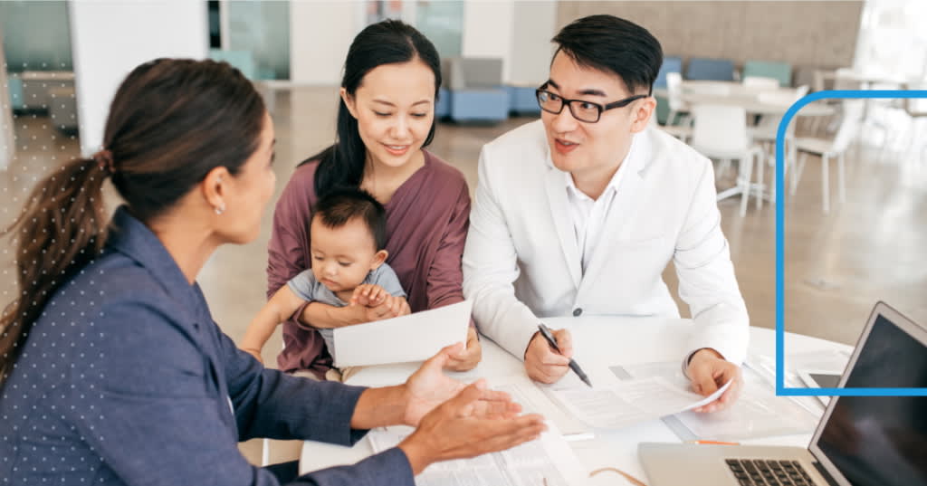 Couple with a baby consulting with a professional.