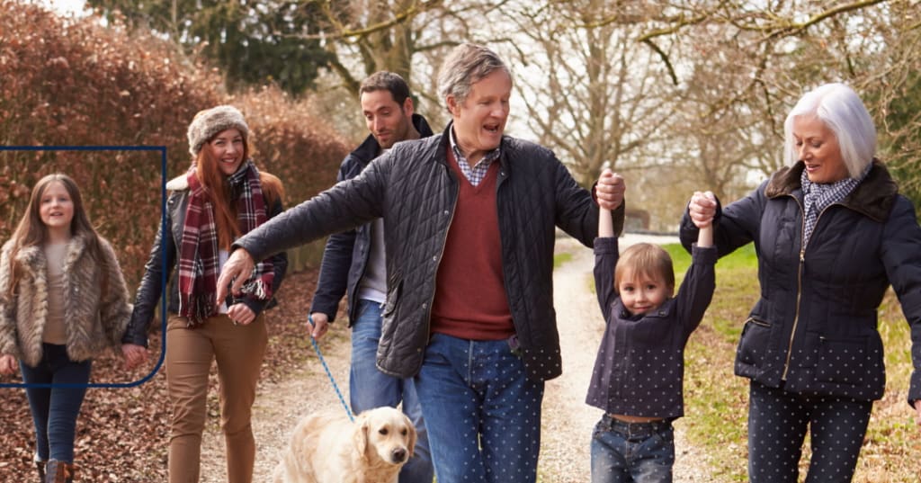 Group of business people, smiling and looking at a laptop.
