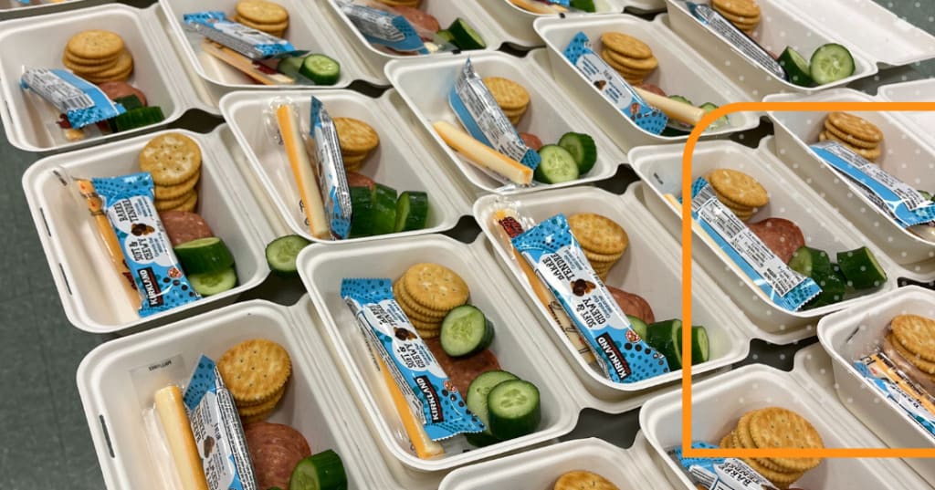 Many take out containers filled with a variety of snacks