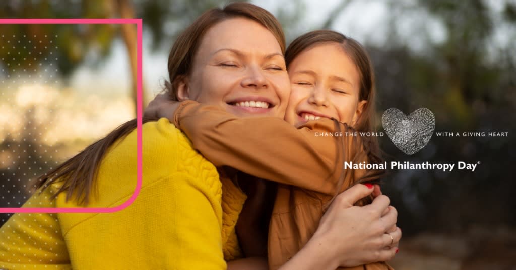 Smiling girl hugging a woman.